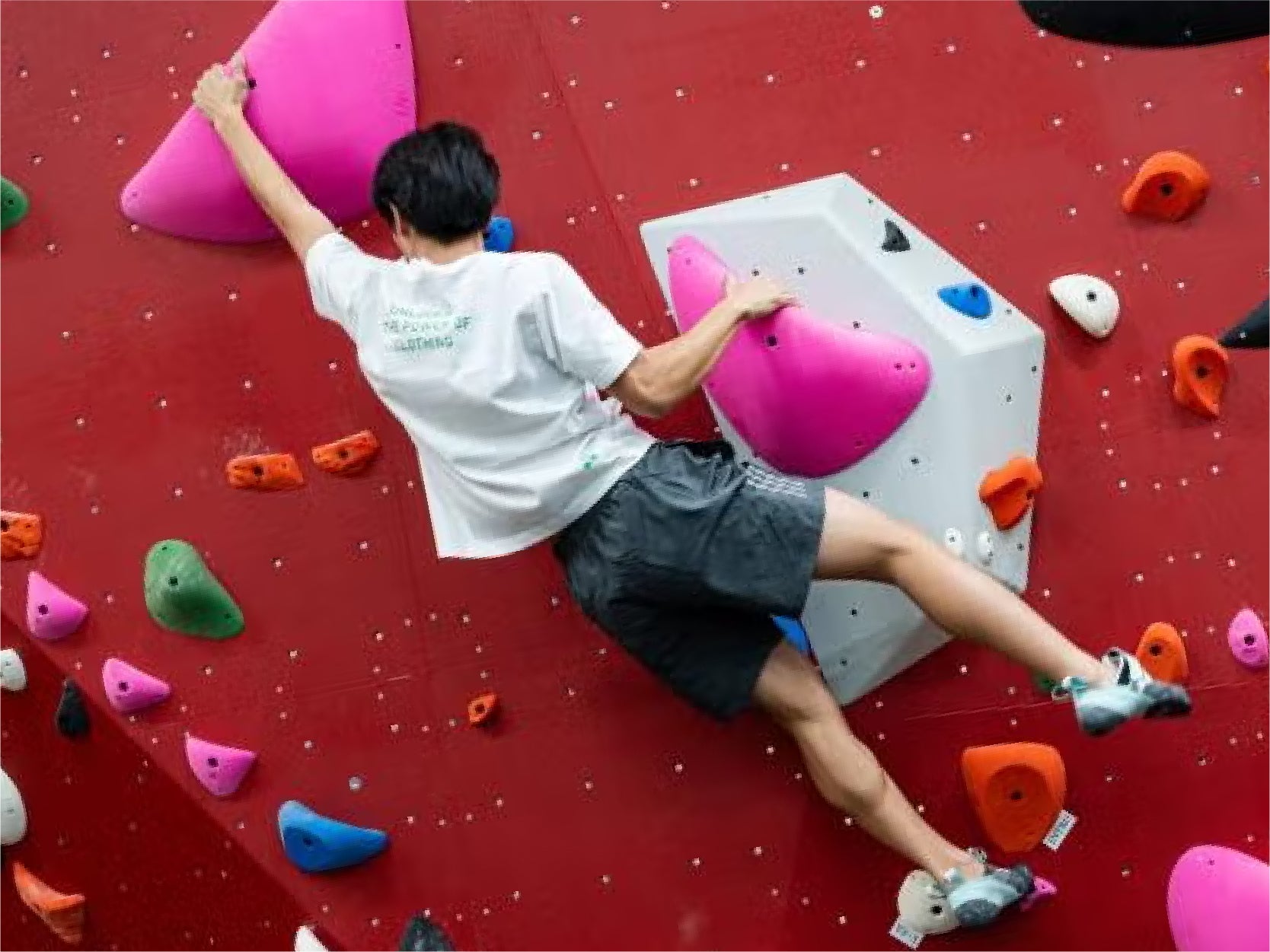 A UMD student climbs RecWell's bouldering wall.